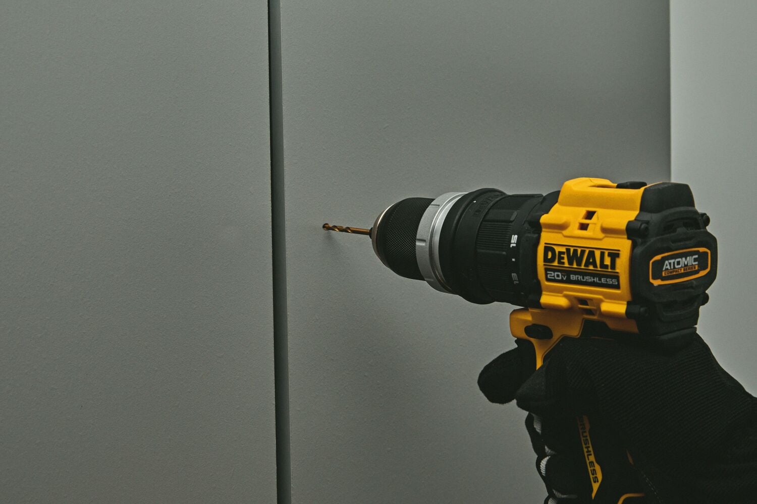 A person drilling using the ATOMIC™ 20V MAX* Multi-Head Drill/Driver with an attachment 