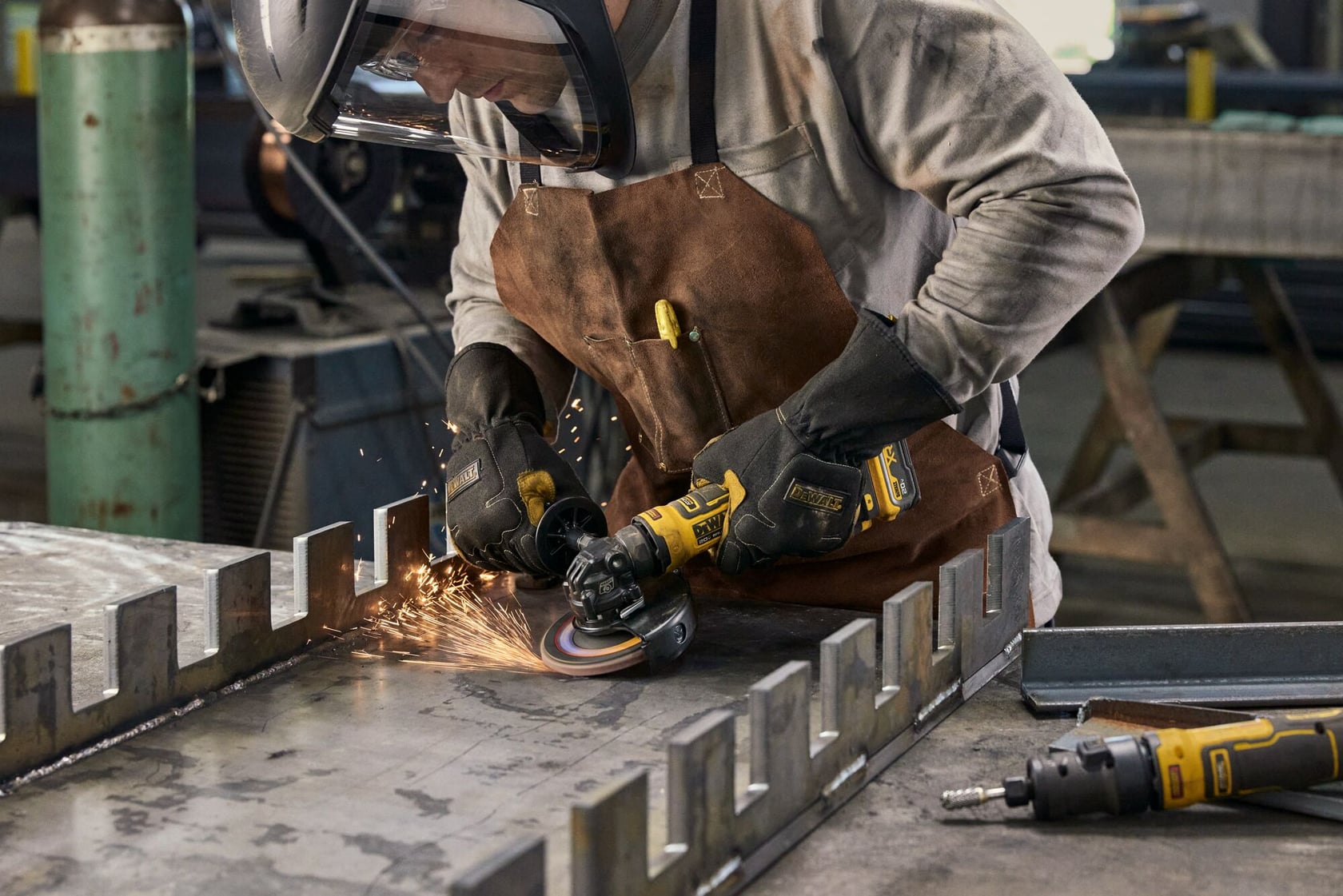 User grinding with ATOMIC™ 20V MAX* 4.5 in. Angle Grinder