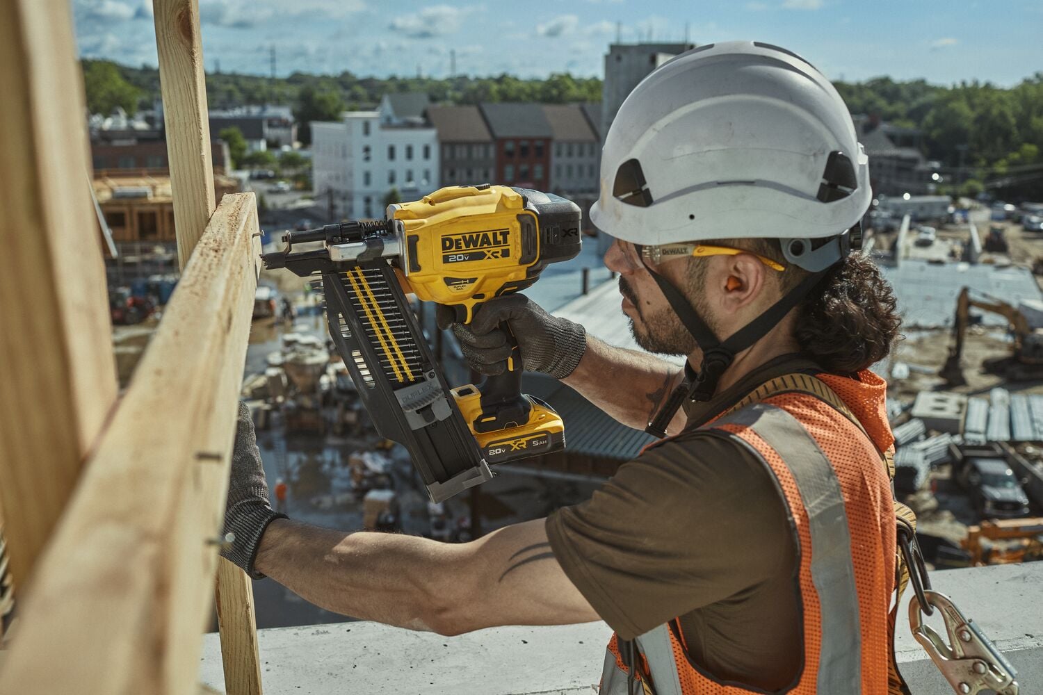 User nailing railing on second story of building using the 20V MAX* XR® Brushless 21° Plastic Collated Duplex Nailer