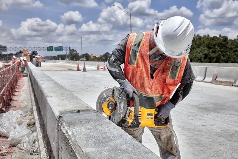 Application image of DEWALT DCS692 cutting into concrete barrier