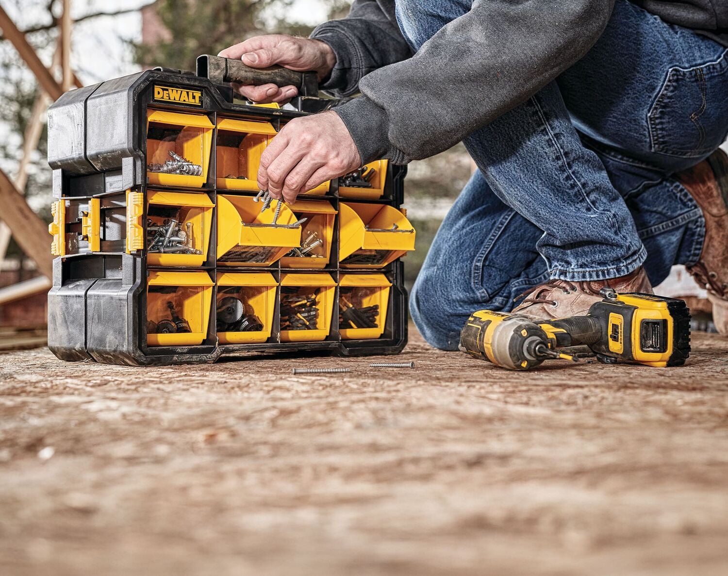 A Pro takes screws out of his DEWALT organizer