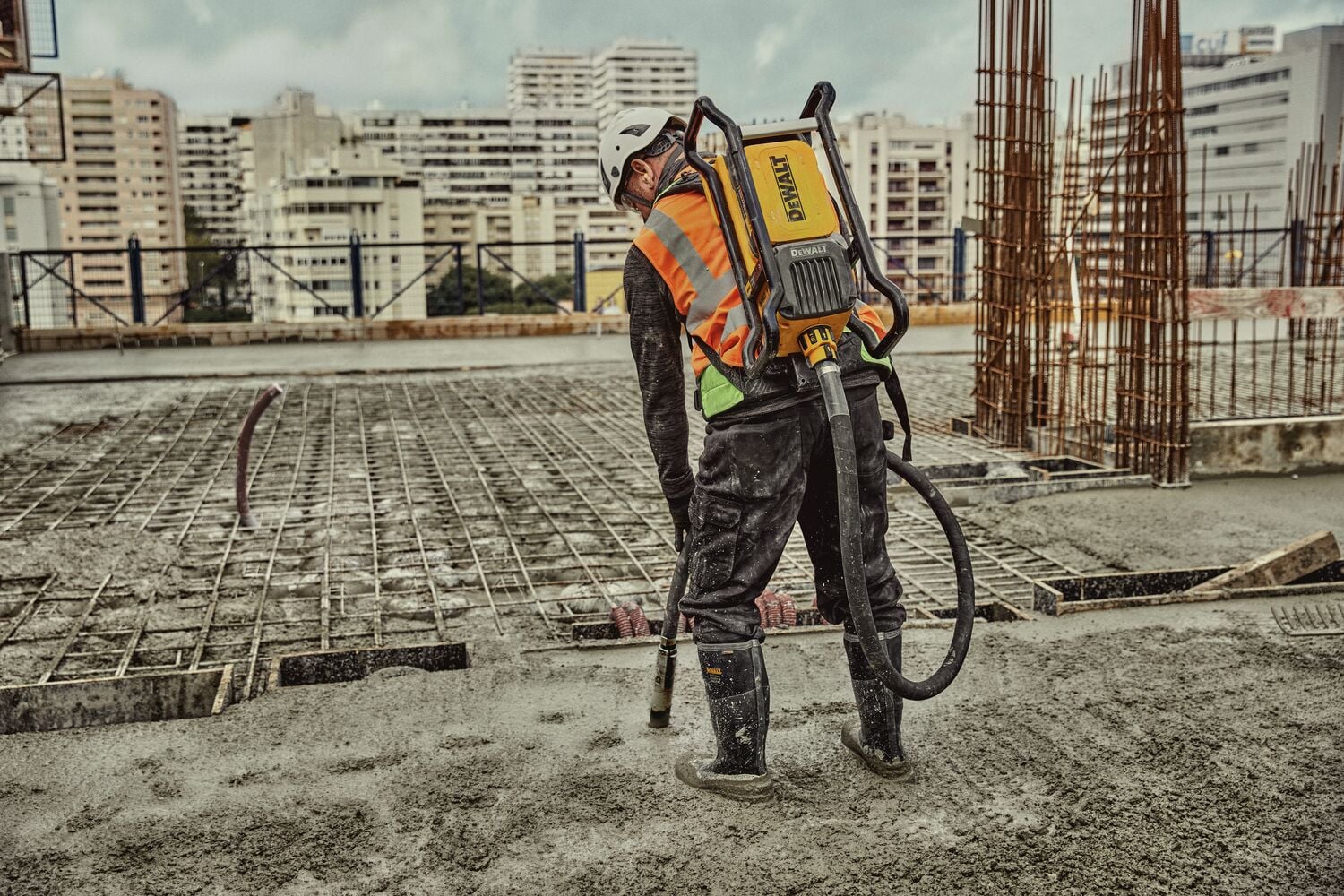 Man operating backpack vibrator