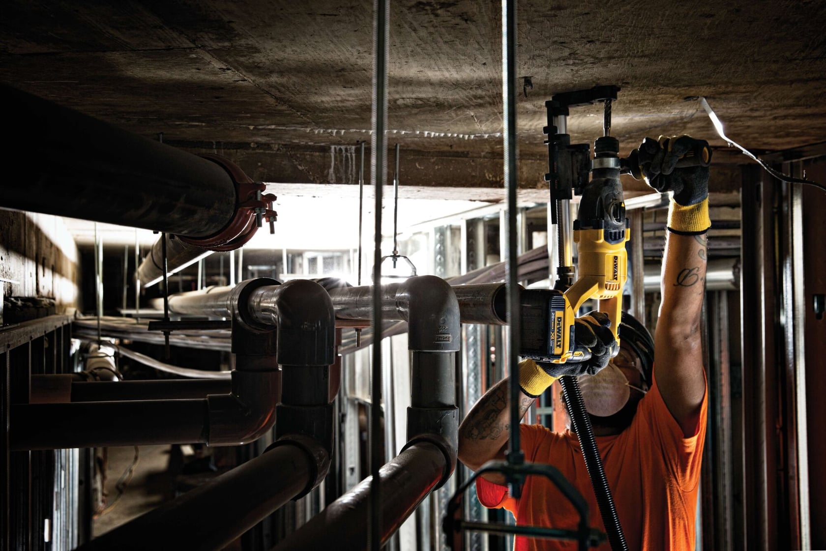 Brushless, cordless SDS PLUS D-Handle rotary hammer being used by a person