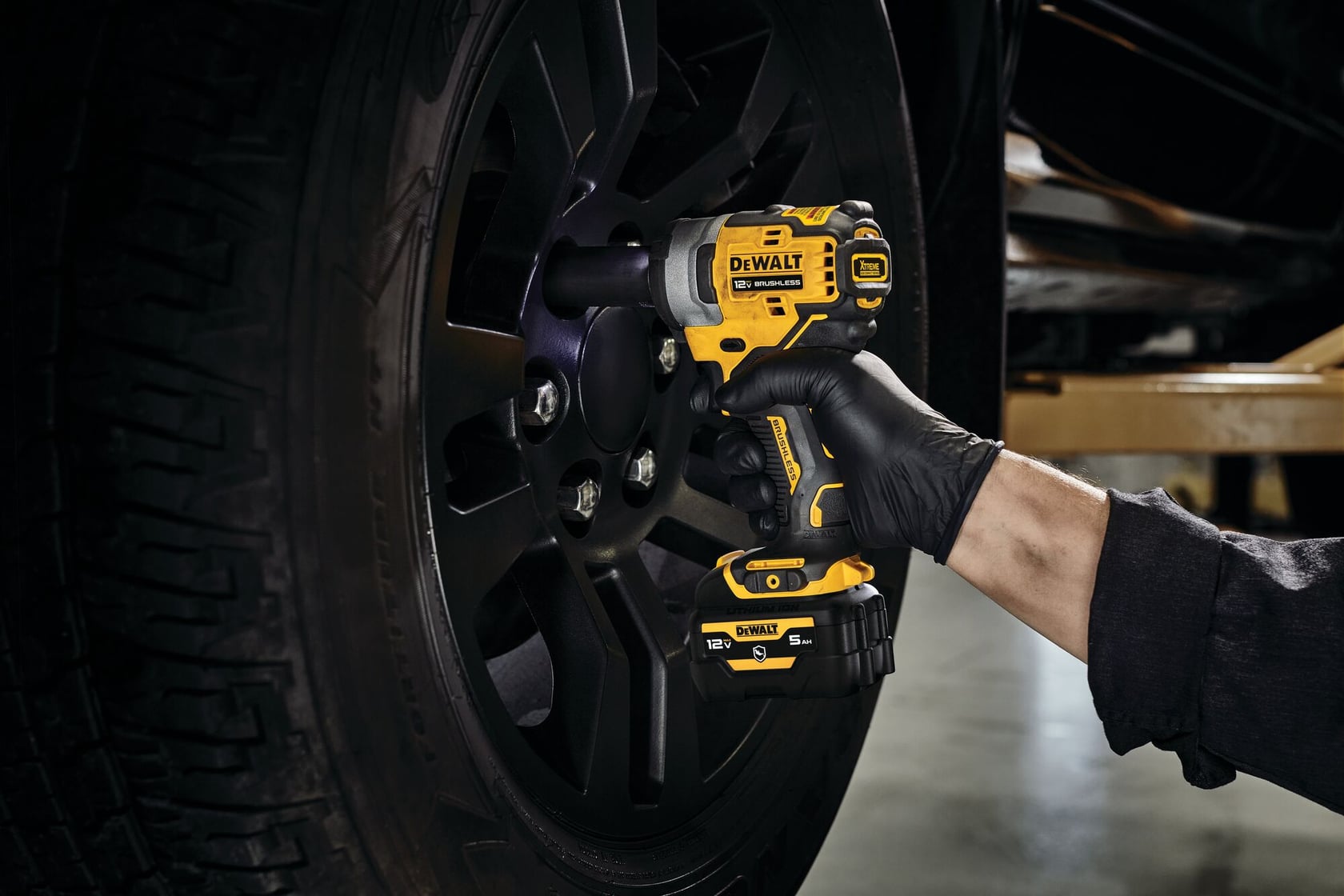 CORDLESS IMPACT WRENCH being used on a tire